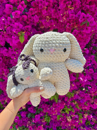 One small and one medium-sized off-white rabbit plushie