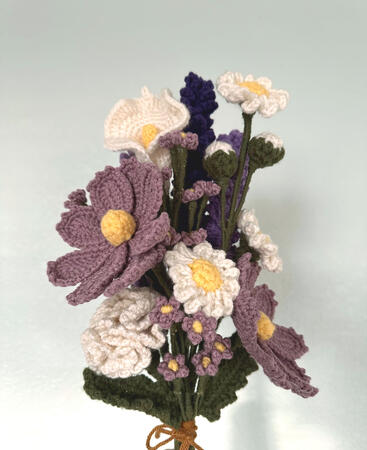 crocheted flower bouquet with white lilies, white daisies, purple lavender, purple gesang, and white buds