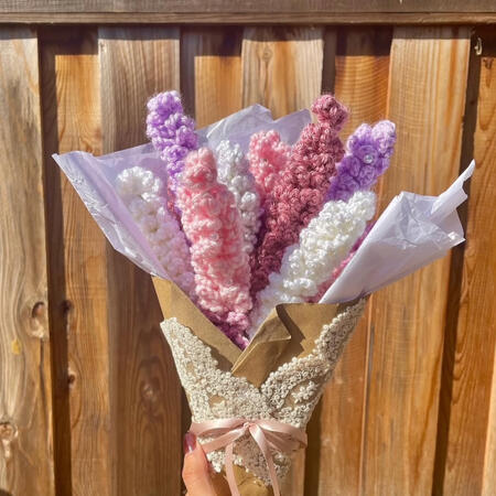 crocheted bouquet with purple, pink, and white lavender wrapped in paper and lace