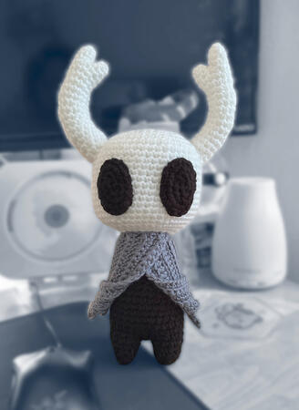 crocheted amigurumi of the playable character in video game Hollow Knight