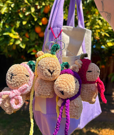 crocheted standing capybaras with fruit hats